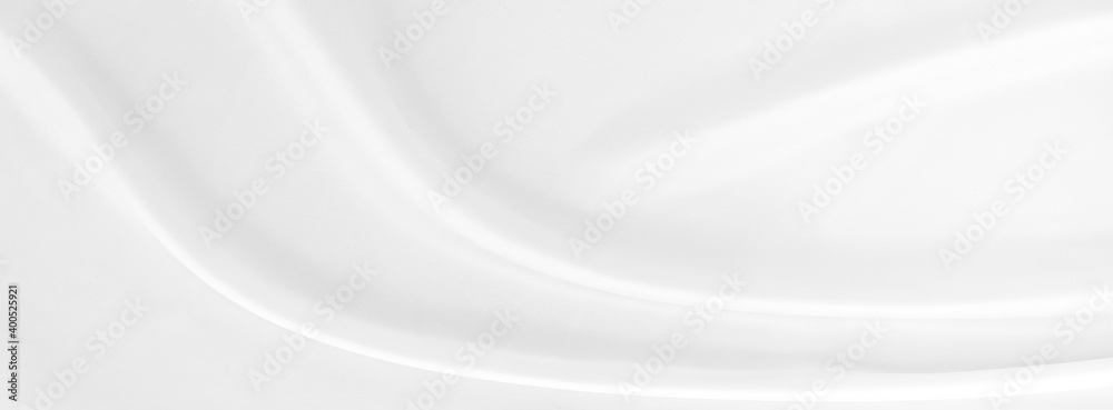 White gray satin texture that is white silver fabric silk panorama background with beautiful soft blur pattern natural.