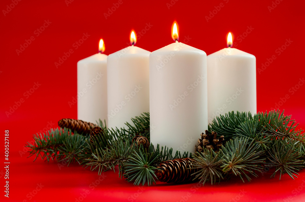 White christmas candles on red background, Advent. 4 burning candles.