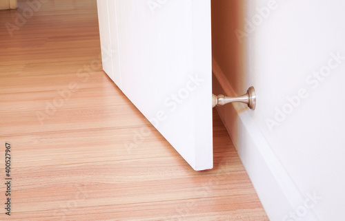 Konstfotografi Stainless Door Stopper with white door and white wall ,selective focus