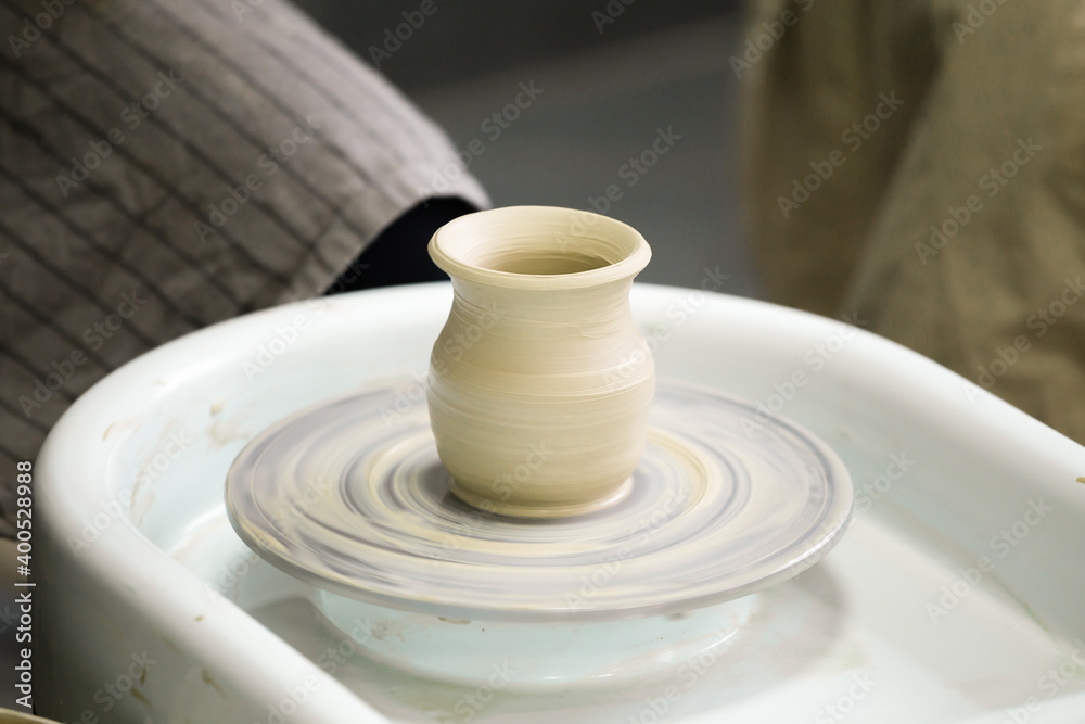 Clay pot on an electric potter's wheel Clay pot on an electric potter's wheel