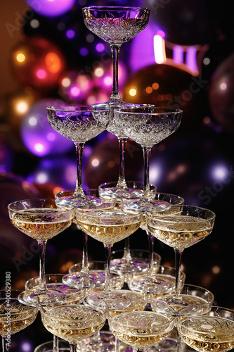 Glasses slide with champagne on Holiday, Birthday, party in restaurant