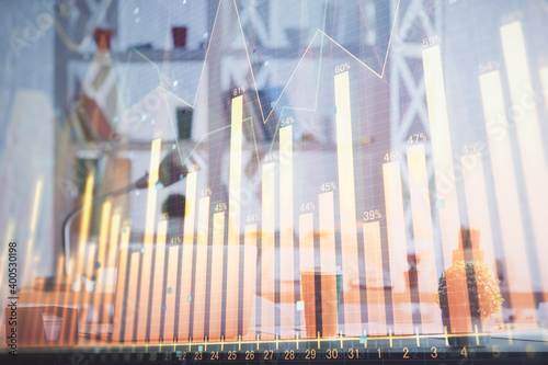 Double exposure of stock market graph drawing and office interior background. Concept of financial analysis.