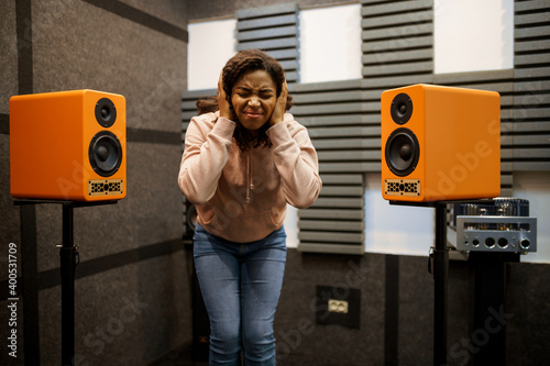 Woman listens to loud music, speaker system store