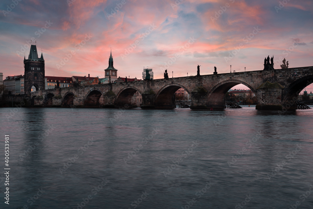 Charles Bridge on the Vltava River at sunset and colorful clouds