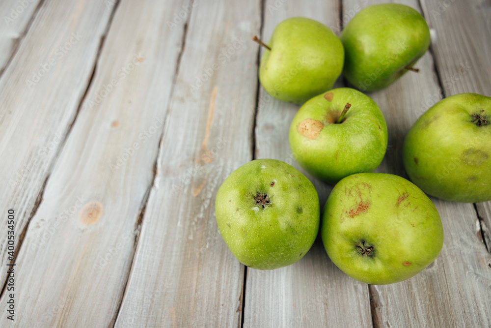 green apple on white wooden background green apple on white wooden background