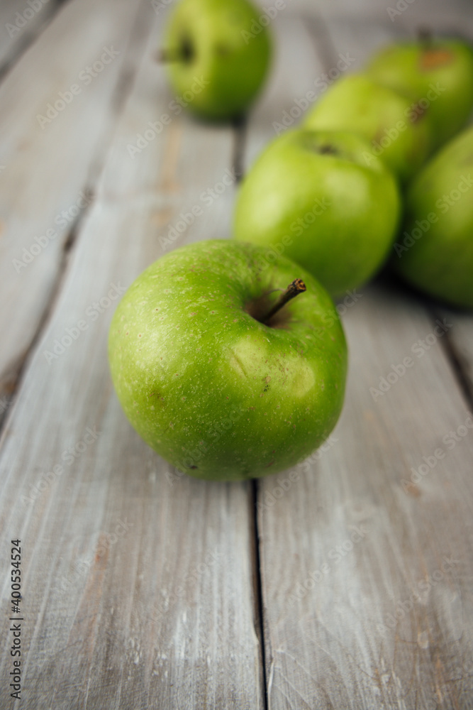 green apple on white wooden background green apple on white wooden background