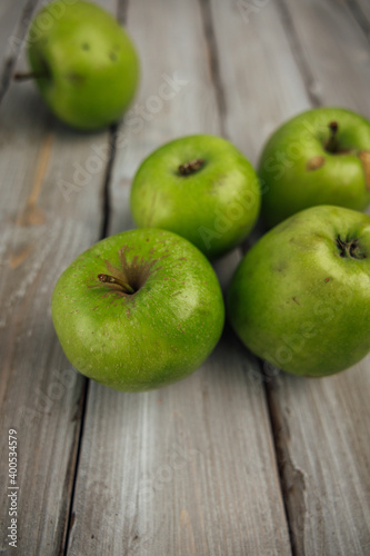 green apple on white wooden background