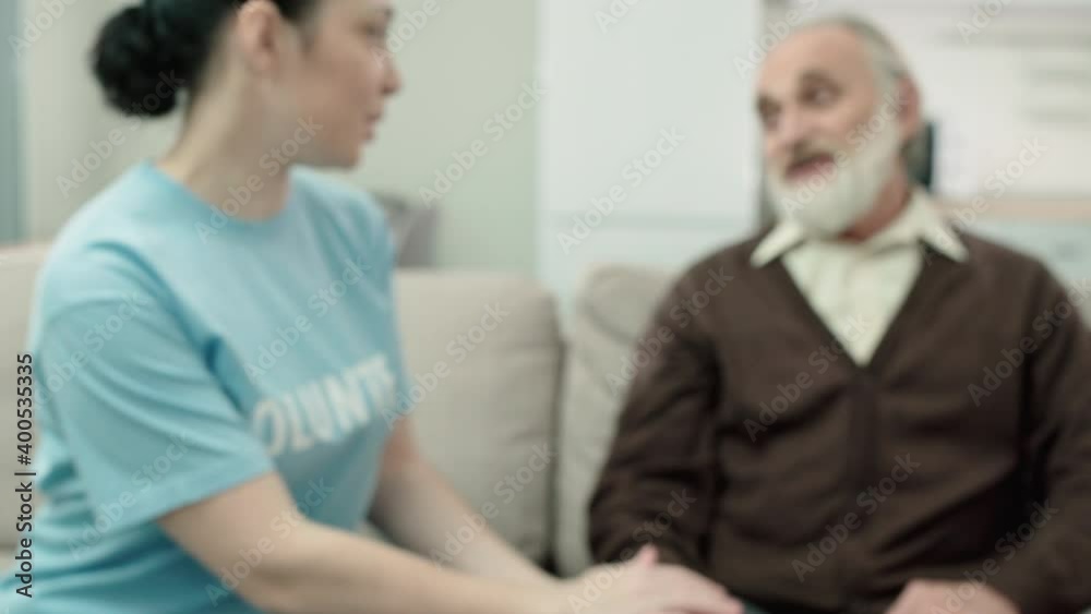 Kind woman stroking aged man's hand, supporting pensioner, voluntary project Kind woman stroking aged man's hand, supporting pensioner, voluntary project