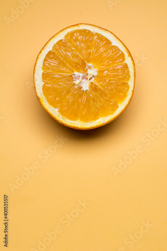 Sliced orange placed on an orange background.
