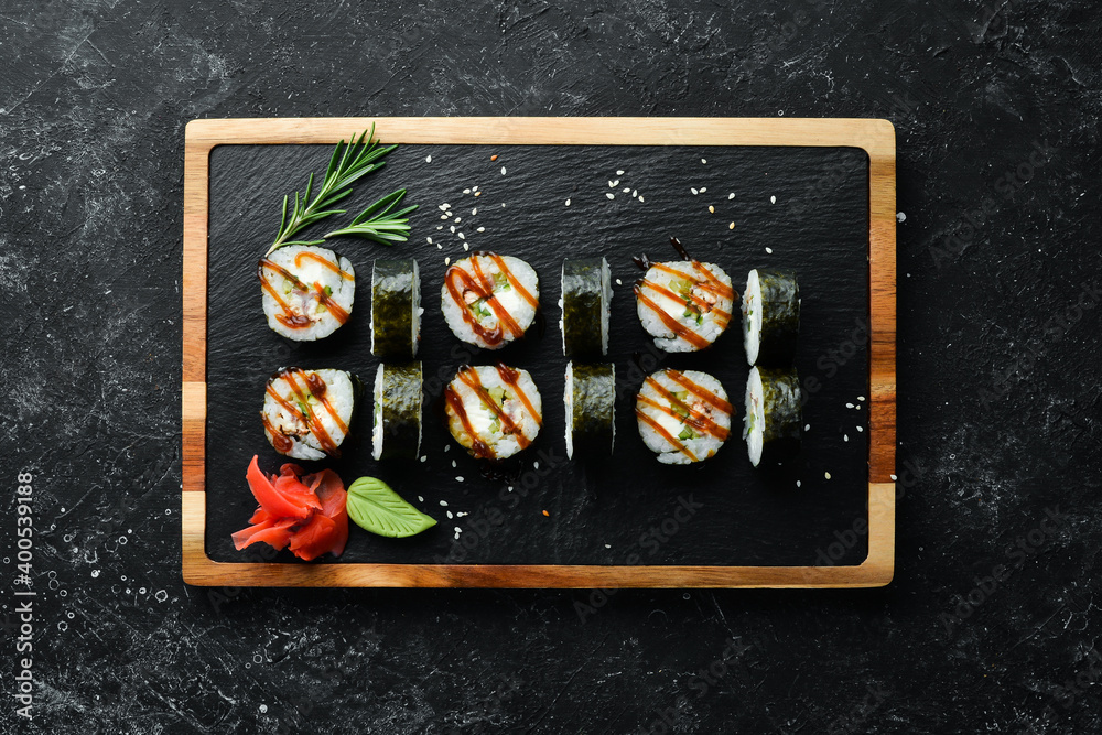 Sushi rolls of seafood - Okinawa. Eel fish, cheese, cucumber and Unagi sauce. Japanese traditional food