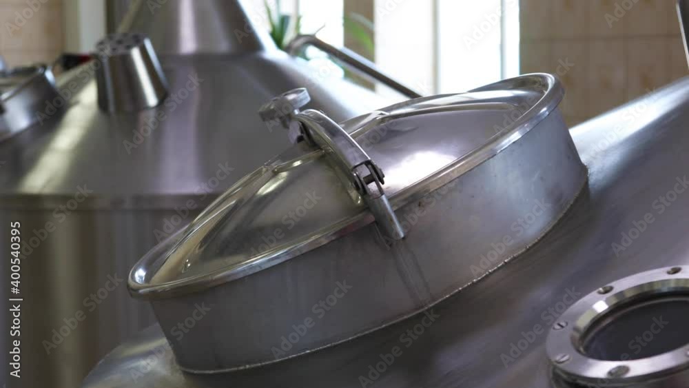 Large metal tanks for brewing beer in a beer factory
