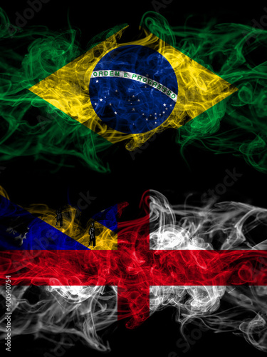 Brazil  Brazilian vs United Kingdom  Great Britain  British  Herm  smoky mystic flags placed side by side. Thick colored silky abstract smoke flags.