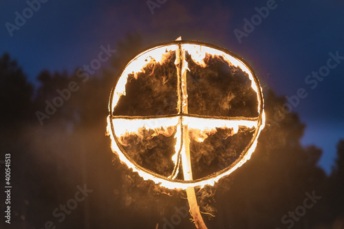 Φωτογραφία Burning symbol of the sun, a sun cross or solar wheel at pagan reenactment of Kupala Night, called in Poland Noc Kupaly