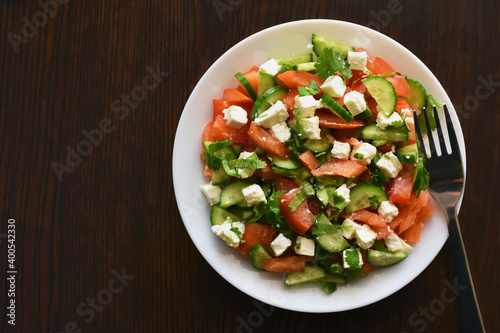 Cucumber and tomato salad with feta cheese. Greek style salad. Healthy and dietary food. Weight loss program meal.