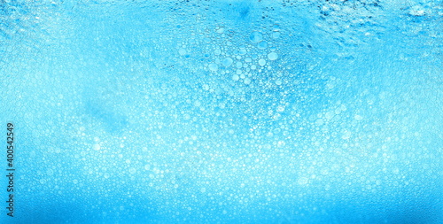Foam blue texture soap bubbles on the water abstract background