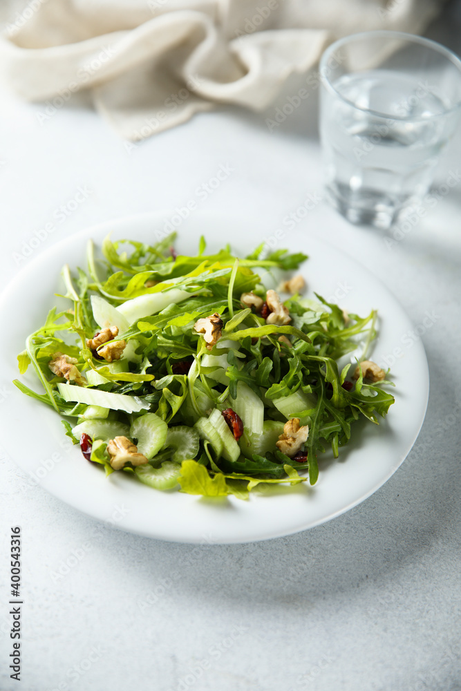 Healthy arugula salad with celery and walnut Healthy arugula salad with celery and walnut