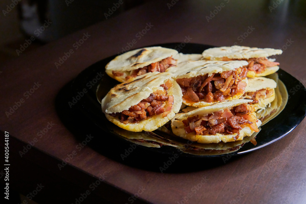 Delicious arepas filled with chorizo, bacon, sausages and cheese Delicious arepas filled with chorizo, bacon, sausages and cheese