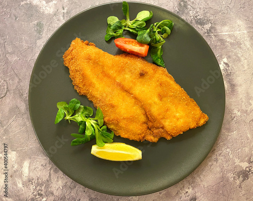 Fotografie, Tablou Classic breaded plaice fish fillets, coated in flour, egg, breadcrumbs and fried in oil to golden