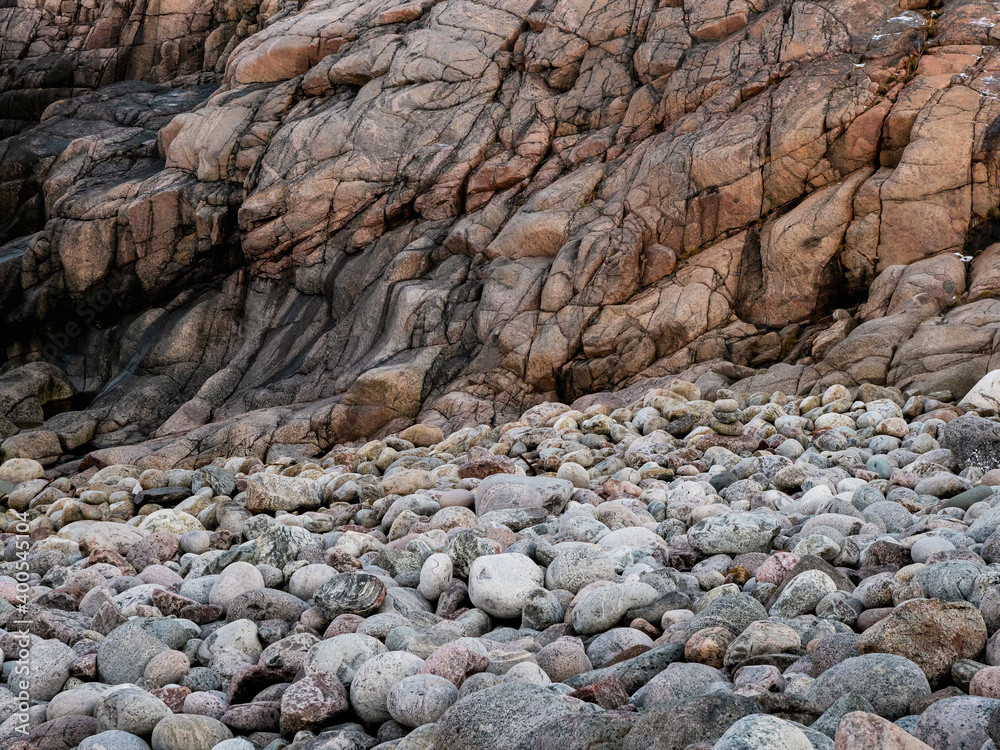 Rock formations and pebbles. Wave texture, a rock formation on the Barents Sea