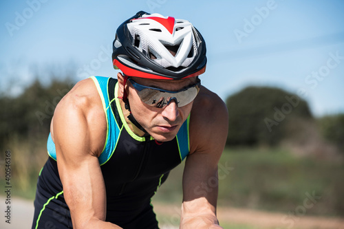 Portrait of a cyclist with helmet and sunglasses riding on a sunny day