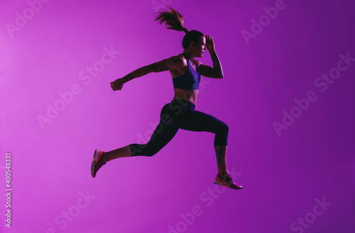 Side view of fit woman running
