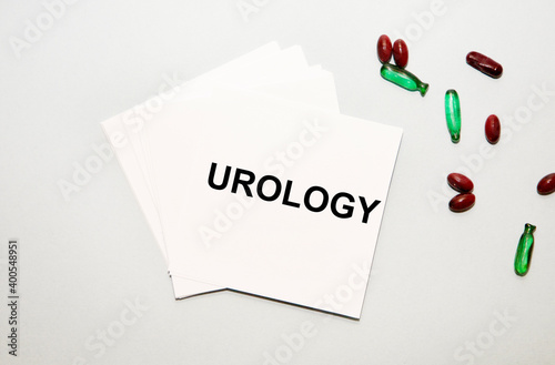 On the notes, the text UROLOGY, next to the red and green capsules.