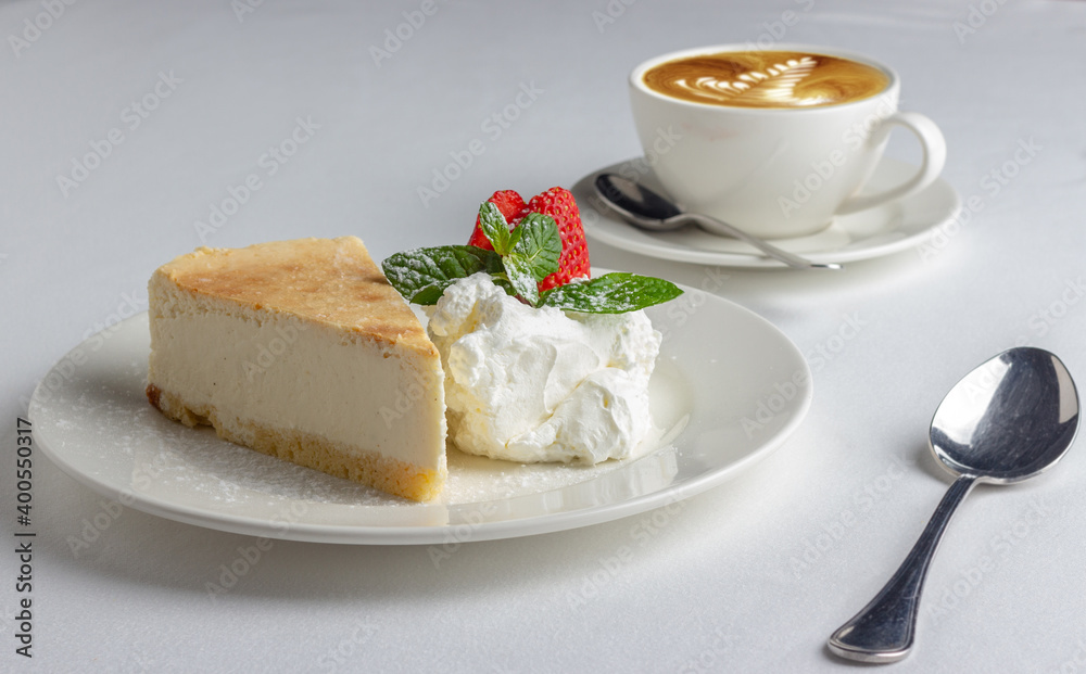 Slice of cake on white table.
Dessert and coffee Slice of cake on white table.
Dessert and coffee