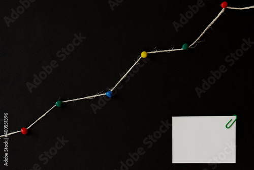 increase graph, development market growth. financial chart productivity, data. concept of progress report. colorful pins and rope, string, copy space. white blank paper with paperclip black background