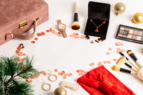 Christmas or new year eve background. Jewelry and makeup presents with neklace, makeup brush, earrings.
