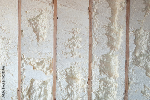 Freshly applied foam insulation in a basement wall