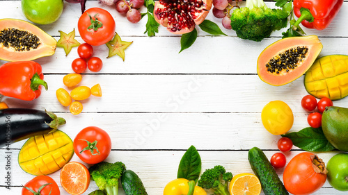 Set of fruits and vegetables on white wooden background. Food background. Top view. Free space for your text.