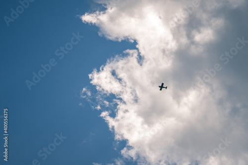 Silhouette airplane flying in the sky surround by blue cloud