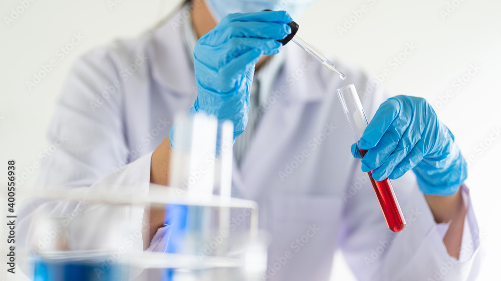 scientists researching in laboratory in white lab coat, gloves analysing, looking at test tubes sample, biotechnology concept scientists researching in laboratory in white lab coat, gloves analysing, looking at test tubes sample, biotechnology concept