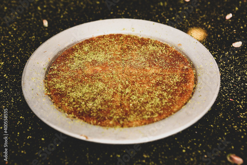 Photography Turkish dessert kunefe, kunafa, kadayif with pistachio powder and cheese hot eat