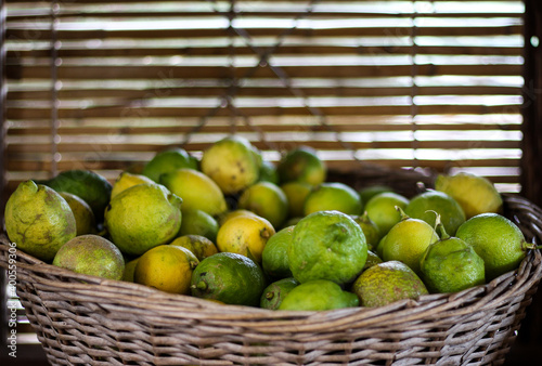 Lemons Lime in a wooden basket container