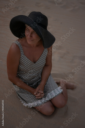 Elegant adult woman silhouette walking near the sea beach. Resort vacation. A person relaxes beauty portrait.