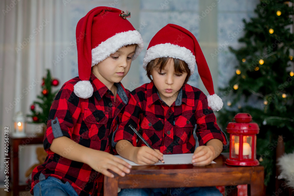 Two adorable children, boy brothers, writing letter to Santa Two adorable children, boy brothers, writing letter to Santa