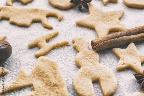 making homemade christmas or new year cookies of different shapes on parchment craft paper
