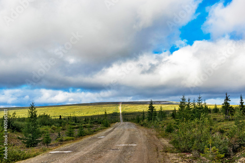 dirt road through the northern tundra to the hill