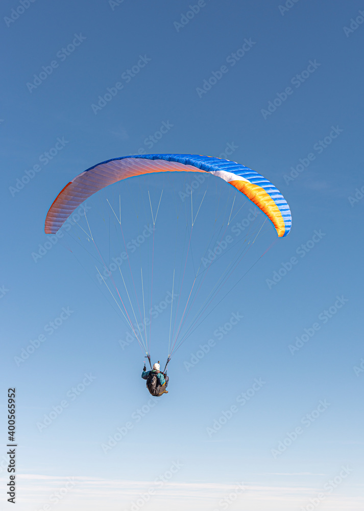 The paraglider is flying in the sky. The paraglider is flying in the sky.