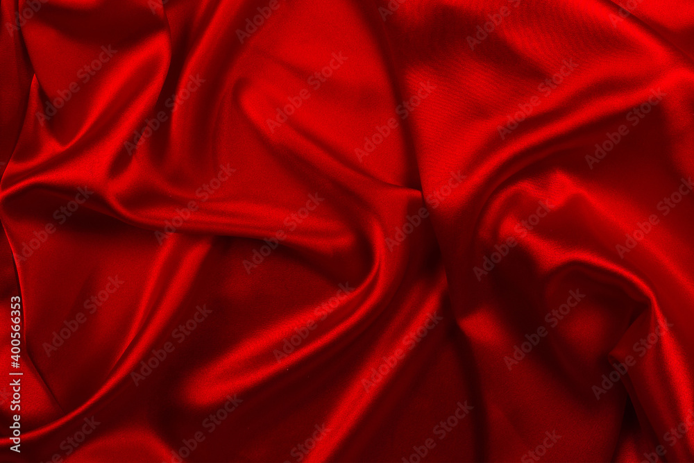 Red silk or satin luxury fabric texture can use as abstract background. Top view.