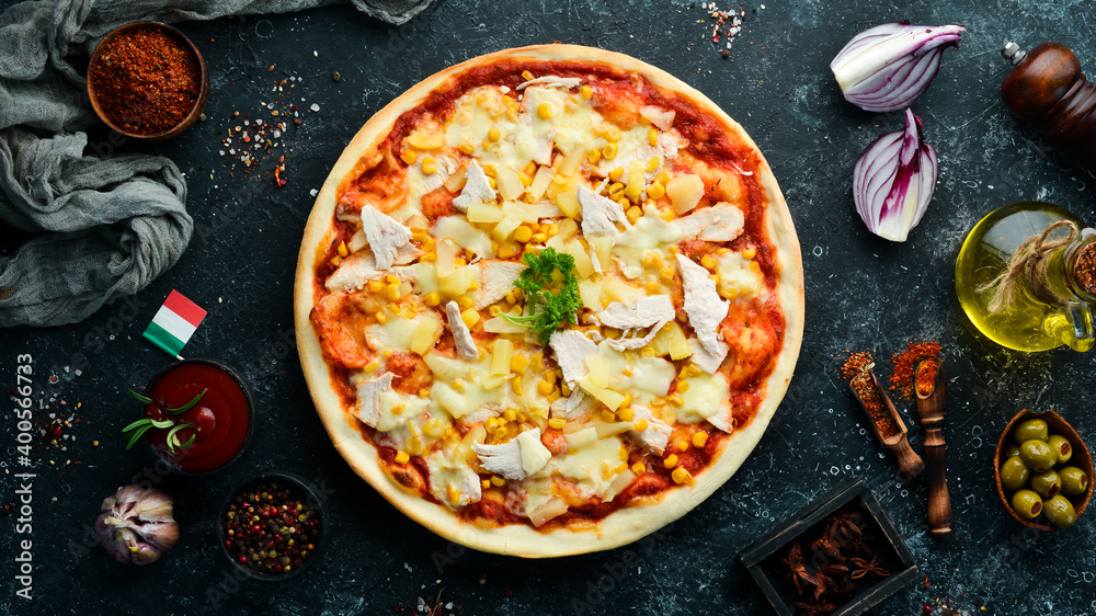 Traditional pizza with chicken, pineapple and corn. Top view. free space for your text. Rustic style.