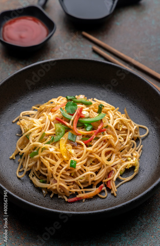 stir fried vegetarian noodles with sauce and chopsticks