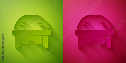 Photography Paper cut Hockey helmet icon isolated on green and pink background