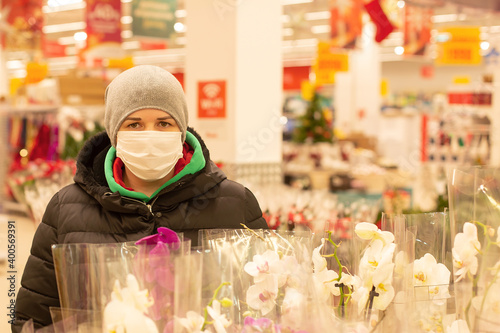 Girl in a protective mask in a supermarket