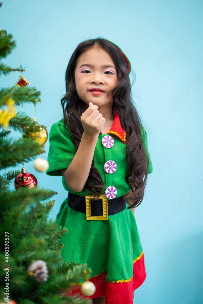 Merry Christmas A girl decorating a christmas tree Merry Christmas A girl decorating a christmas tree