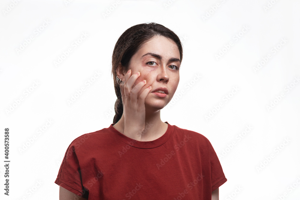 Portrait of a young woman with a ghostly hand scratching her face. White background. The concept of psychology and Mental Health Day Portrait of a young woman with a ghostly hand scratching her face. White background. The concept of psychology and Mental Health Day