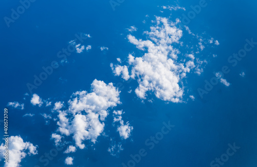 Photography White clouds taken from the airplane against the blue ocean underneath