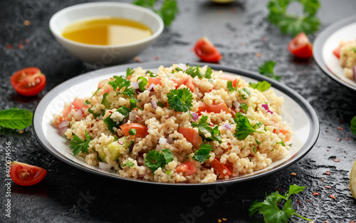 Tabbouleh salad with tomato, cucumber, red onion, bulgur and parsley. Healthy vegan food