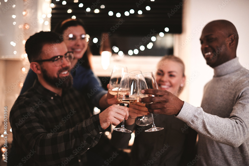Diverse friends toasting with wine during a dinner party